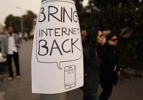 paper sign on pole says Bring Internet Back