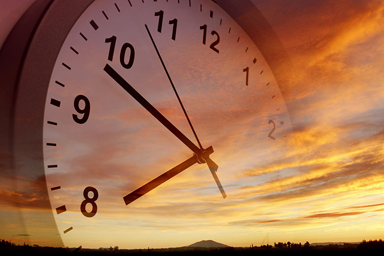 Clock over evening scenery background