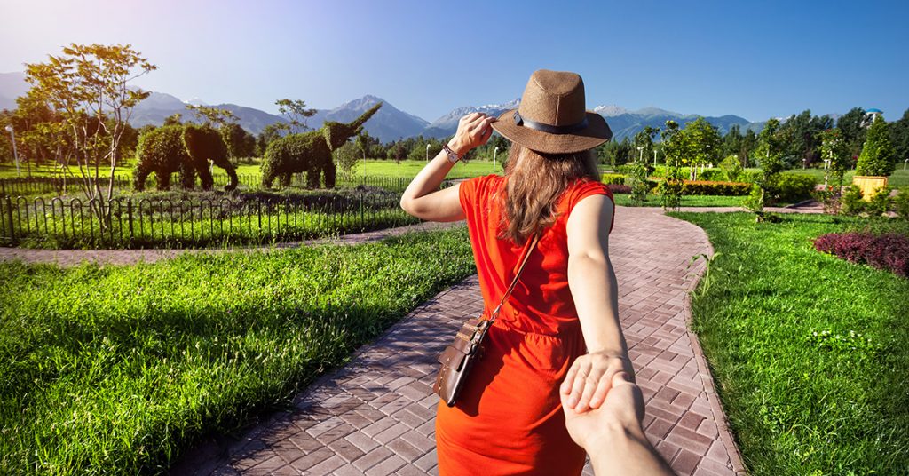 person holding woman's hand in mountain scenery